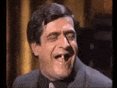 a man with a tooth missing is laughing with his mouth open