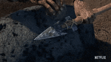 a netflix ad shows a person holding a spear in their hands