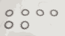 a person is playing with a bunch of metal beads
