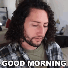 a man with long curly hair and a beard says good morning