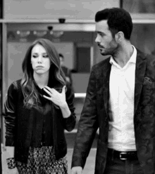 a black and white photo of a man and woman