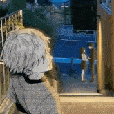 a man and a woman are standing next to each other in front of a window .
