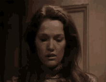 a close up of a woman 's face looking up