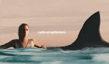 a woman is swimming next to a shark with the words radical optimism written on the bottom