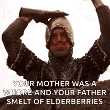a knight in armor is holding a sword over his head .