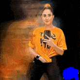 a woman taking a selfie with a yellow shirt that says t2 on it