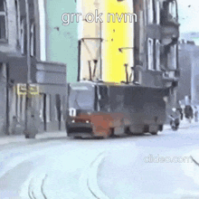 a bus is driving down a city street next to a motorcycle .