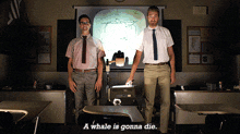 two men standing in front of a projector screen with the words a whale is gonna die