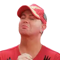 a man wearing a red hat and a red shirt is making a face with his eyes closed