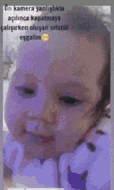 a close up of a baby 's face with a caption that says " kamera yanlislikla açilince kapatmaya "