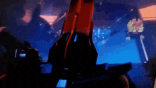 a person is holding a red object in their hands in a dark room