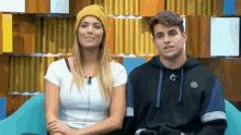 a man and a woman are sitting next to each other on a chair .
