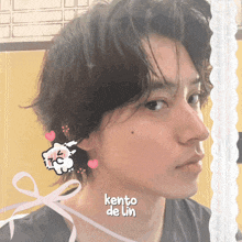 a close up of a person 's face with the name kento de lin on it