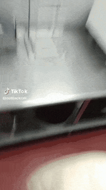 a tiktok video of a table with a red floor