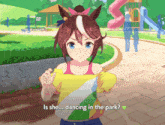 a girl in a yellow shirt is dancing in a park