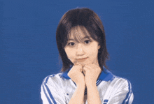 a blurry picture of a woman 's face and arm against a blue background