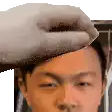a close up of a person 's head with a cat 's hand on it .