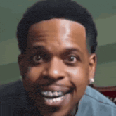 a close up of a man 's face with a big smile on it .