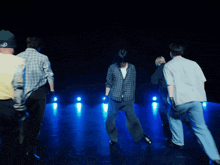 a group of young men are dancing and one of them is wearing a t-shirt that says yes