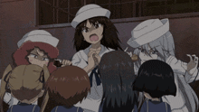 a group of girls are standing around a man wearing a white hat