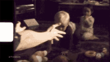 a person is reaching out to touch a child 's face in a nbc video .