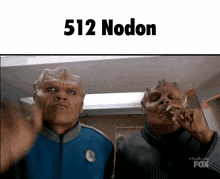 two aliens standing next to each other with the words 512 nodon on the bottom