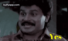a man with a mustache is smiling with the words yes written below him .