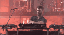a man is playing a roland keyboard on stage