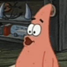 patrick star from spongebob squarepants is making a surprised face in a close up of his face .