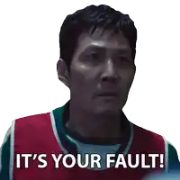 a man says it 's your fault while wearing a red and green vest
