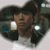 a close up of a man 's face with a heart shaped frame around him