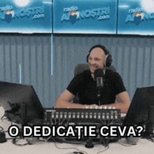 a man wearing headphones sits in front of a microphone with the words " o dedicatie ceva " above him