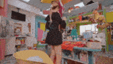 a woman in a black dress is standing in front of a table with a sign that says no smoking