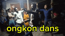 a group of people are dancing in front of a sign that says ' okong dans '