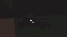 a white arrow pointing to a red object in the dark .