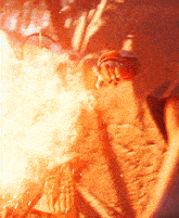 a close up of a person holding a fireball in their hand