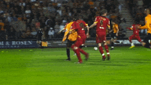 a blurry picture of a soccer field with a goalie in the foreground