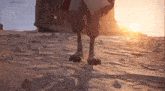 a cartoon character 's legs are shown in the sand