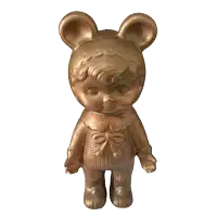 a bronze figurine of a baby bear with a bow on the waist