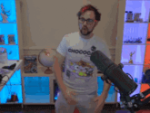 a man in a chococat t-shirt is standing in front of a microphone