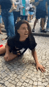 a woman is laying on the ground with her legs crossed .