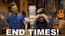 two men are sitting in front of a microphone with the words end times written in white letters