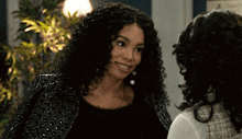 two women are standing next to each other and smiling