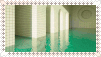 a postage stamp with a picture of a room with green carpet and white walls .