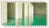a postage stamp with a picture of a room with green carpet and white walls .