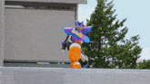 a person in a purple and blue costume is riding a robot