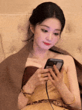 a woman in a strapless dress is looking at her cell phone