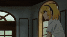 a girl with blonde hair is standing in a room with arched windows