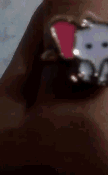 a close up of a person wearing a ring with an elephant on it