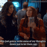 two women sitting at a table looking at their phones with the caption i 'm just gonna write some of my thoughts